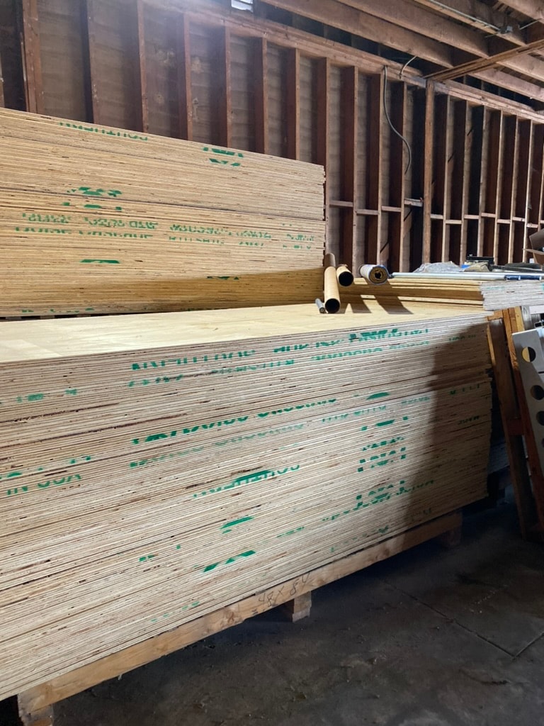 Stacked plywood sheets at the Matmen warehouse, available for rental for film and TV location ground protection in Los Angeles